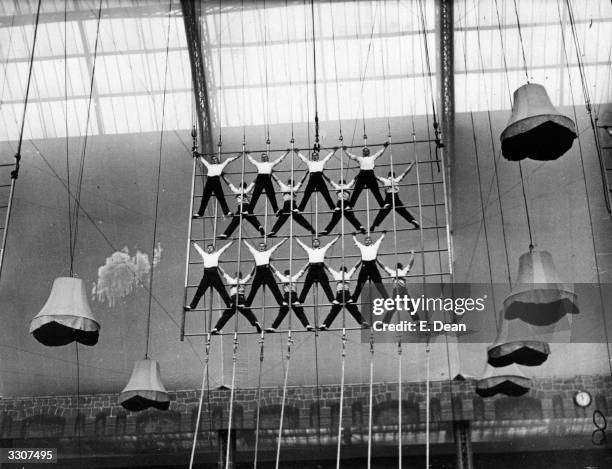 Cadets of the Rayal Naval School, Portsmouth, rehearsing the rope-climbing exhibition at Olympia, London, which they will perform at the Royal Naval...