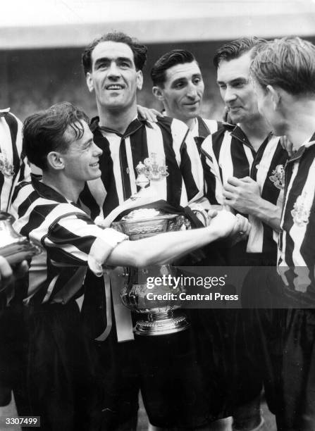 Newcastle United players celebrate their 2-0 win over Blackpool in the FA Cup Final at Wembley. Captain Joe Harvey is with the trophy and Jackie...