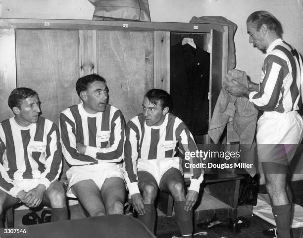 Sir Stanley Matthews , aged 50, in the changing room with three Tottenham Hotspur players Cliff Jones, Alan Gilzean, Jimmy Greaves, before playing a...