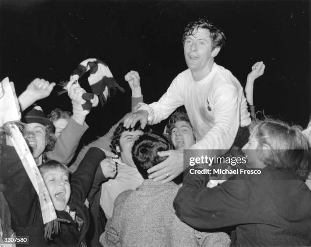 Jubilant Tottenham Hotspur fans carry Alan Mullery around White Hart Lane after Spurs' UEFA Cup win over Wolverhampton Wanderers. Mullery scored...