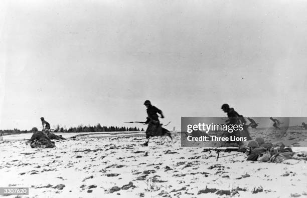 Russian infantrymen advancing in a sector on the front during the Great Patriotic War.