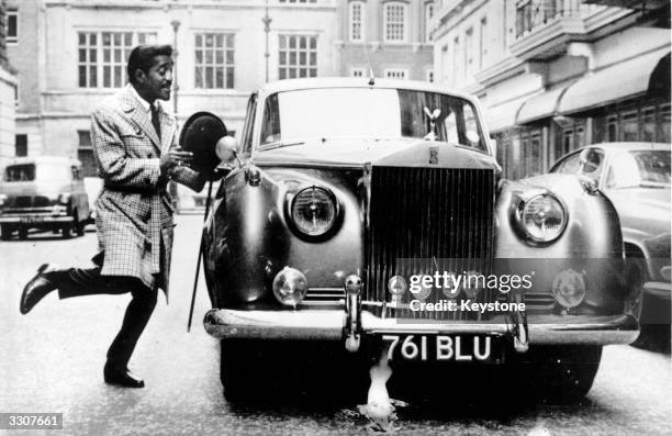 Year old singer, film star and Sinatra clan member Sammy Davis Junior skips to his Rolls Royce, he is in England for a week of variety performances...