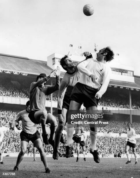 Alan Gilzean of Tottenham Hotspur leaps for the ball during a raid on the Wolverhampton Wanderers goal during their match at White Hart Lane....