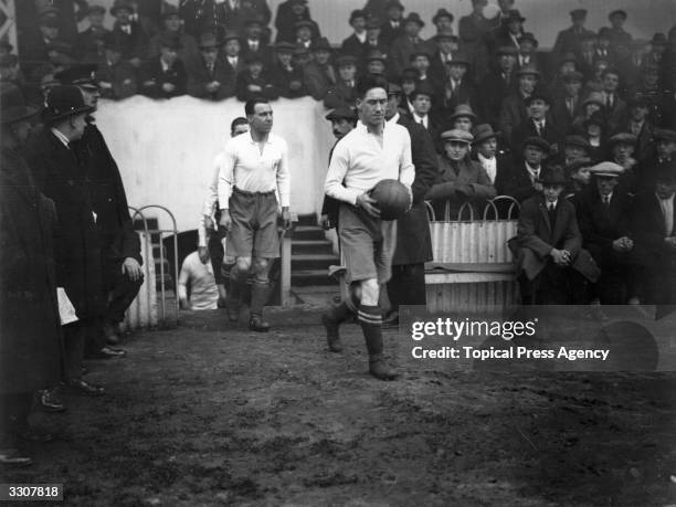 Jimmy Seed leads the Tottenham Hotspur team on to the pitch at White Hart Lane for their first round FA Cup match against Northampton Town.