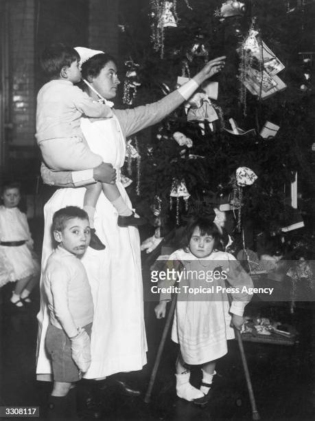 Nurse and patients at a Christmas party at Great Ormond Street Hospital for Sick Children, London.