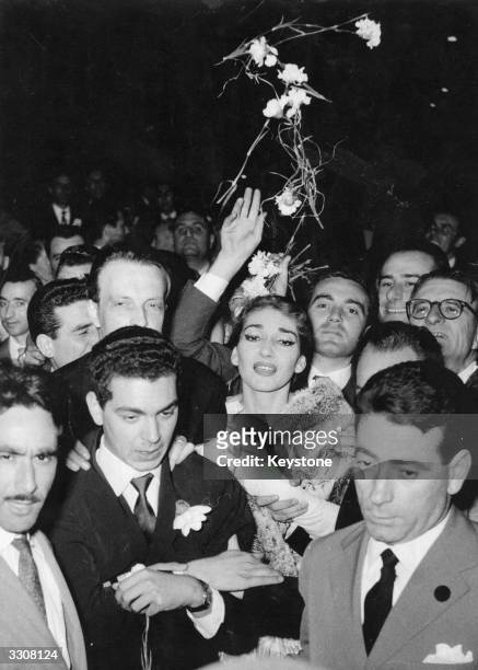 American born Greek soprano Maria Callas , surrounded by admirers leaves La Scala Opera House, Milan, after her last performance there, in the wake...