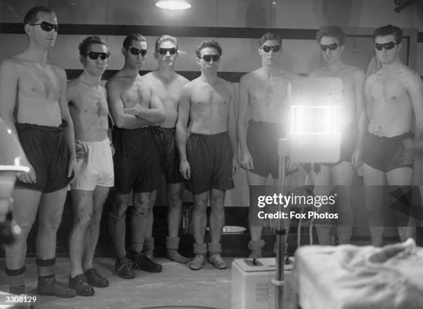 Eight of West Ham United Football Club's players during an ultra-violet ray treatment session at their grounds at Upton Park, east London.