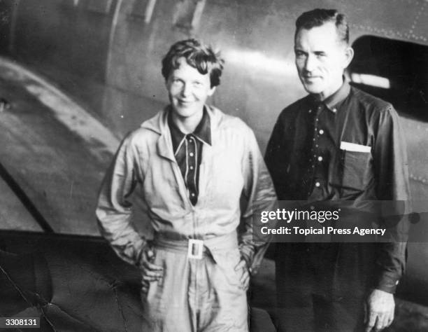 American aviatrix Amelia Earhart with her navigator, Captain Fred Noonan, in the hangar at Parnamerim airfield, Natal, Brazil, 11th June 1937....