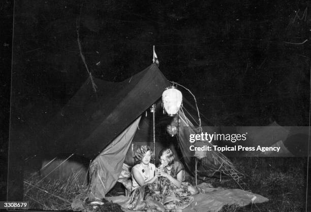 Two ladies of the Annual Reunion of Members of the Camping Association of Great Britain and Ireland at Bulstrode Park, Buckinghamshire, choosing to...