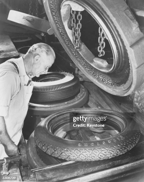 William H Links, who has worked for the Firestone Tyre and Rubber Company in Akron, Ohio, for 40 years, watches the production of both old and new...