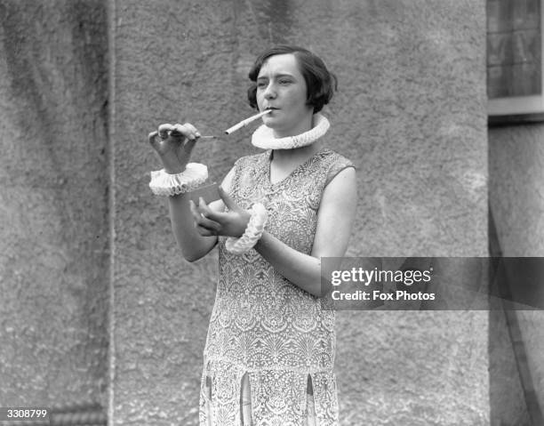 Woman smoking a large cigarette and wearing ruffles at collar and cuff.