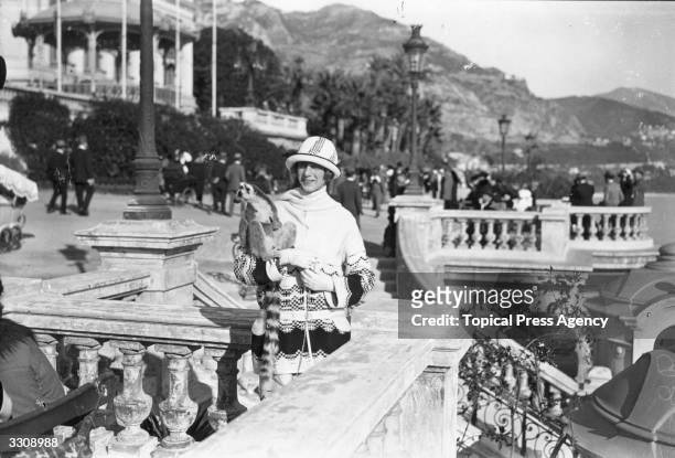 Mrs Charles Bentinck-Budd on the terrace at Monte Carlo with her pet lemur.