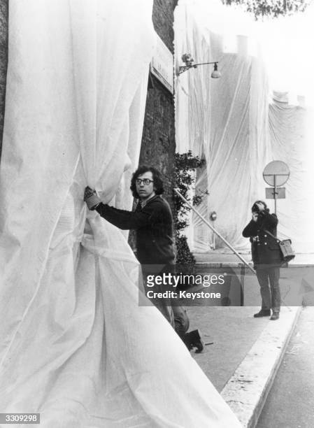 Javacheff Christo, Bulgarian artist, wrapped a section of the famous Aurelaian wall, the Via Veneto in Rome, with plastic sheet, as part of his...
