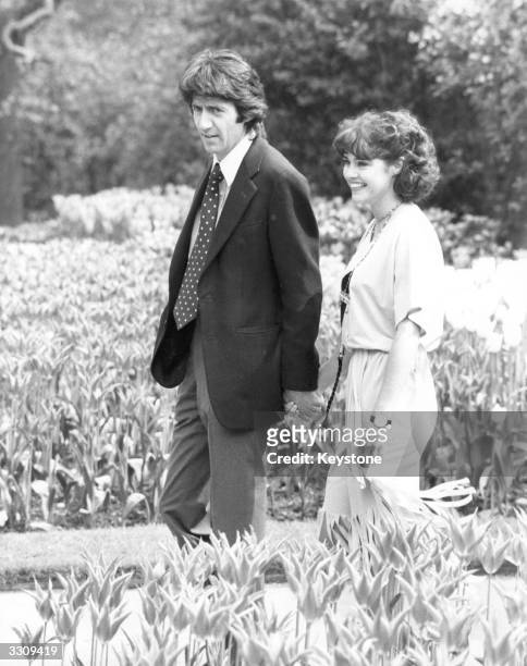 Gemma Craven and Tom Conti walking in Temple Gardens, London to publicise the musical 'They're Playing Our Song'.