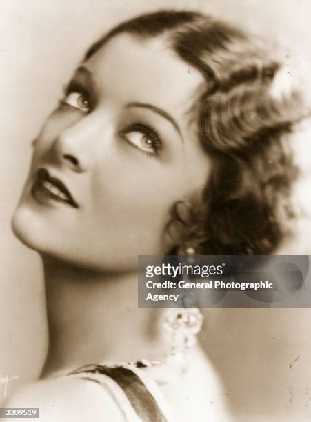 Myrna Loy , the Hollywood film actress, usually cast as an exotic vamp. In 1936, the height of her career she was declared 'Queen of the Movies'.