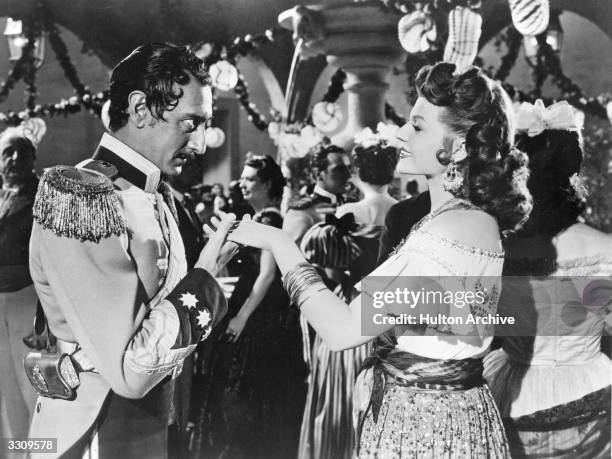 Rita Hayworth Arnold Moss share a romantic scene from 'The Loves Of Carmen' about a dragoon corporal in Seville, who becomes enslaved by a gypsy,...