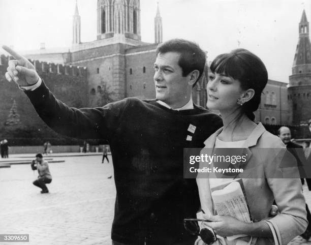 Tony Curtis pointing out some of the sights in Red Square to his wife, Christine Kaufmann. They are in Moscow to attend the 3rd International Film...