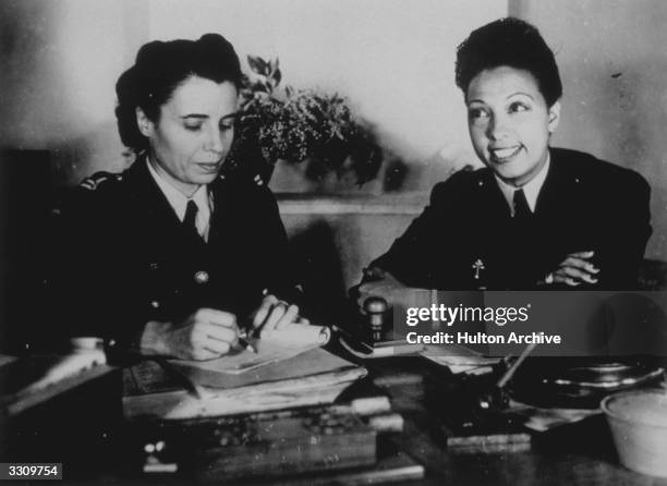 American born entertainer, dancer and singer Josephine Baker , right, as a volunteer in the Free French Women's Air Auxiliary.