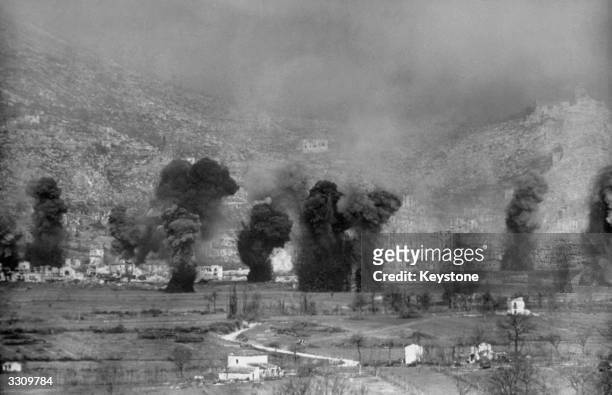 Earth and rubble are thrown skyward as Allied planes and guns pound Cassino, the German bastion in Western Italy.