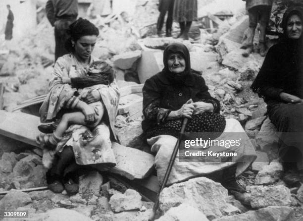 Four generations of Greek peasants amid the ruins of their home.