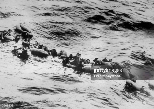 Survivors of a German submarine, which was sunk in the Atlantic by the Canadian corvette 'St Thomas', cling to their rubber rafts as they await...