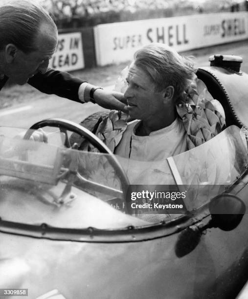 Peter Collins in the Ferrari in which he won the British Grand Prix at Silverstone. Mike Hawthorn was second, also driving a Ferrari.