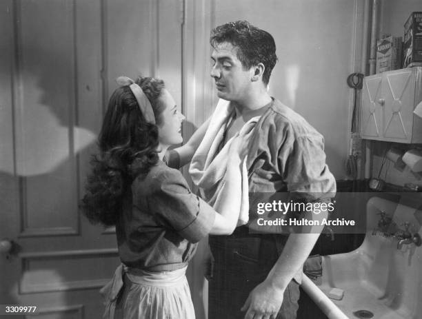 Victor Mature with Coleen Gray in a scene from the thriller 'Kiss Of Death', directed by Henry Hathaway for 20th Century Fox.