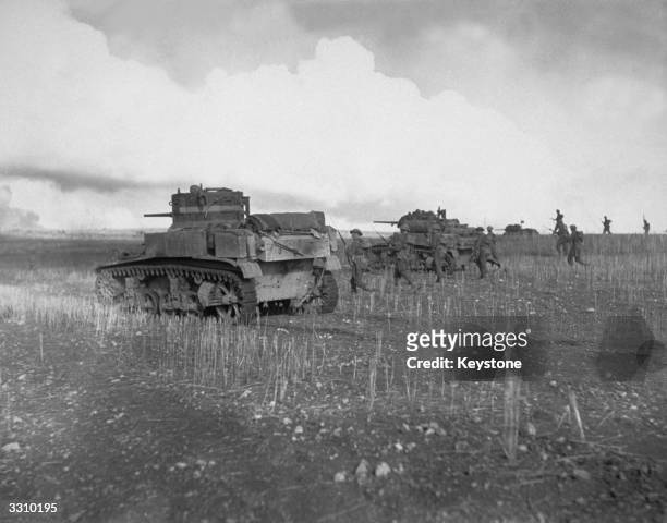 British troops advancing supported by American tanks on the Tunisian front.