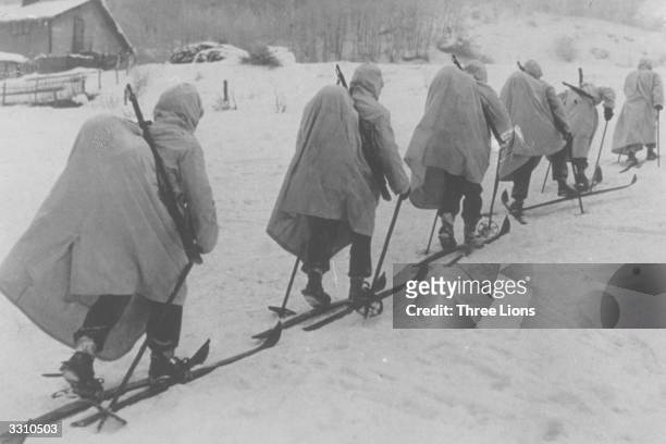 Finnish ski troops advancing north of Lake Ladoga, carrying their provisions in knapsacks on their backs.