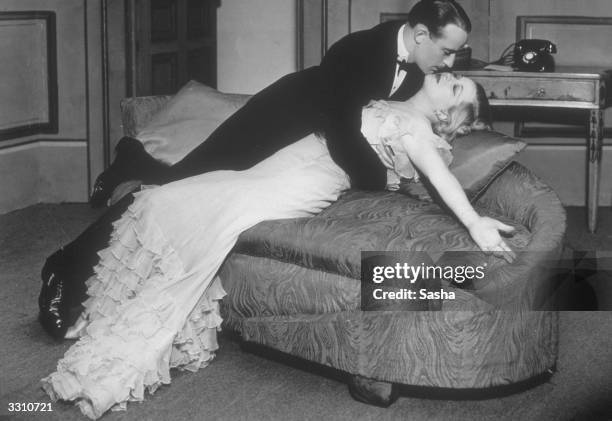 Couple embrace passionately, in a scene from the play 'Gay Love', at the Lyric Theatre, London.