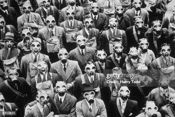 Some of London's telephone operators and engineers, trying out their gas masks at the anti-gas civilian training centre in Gloucester, where they...