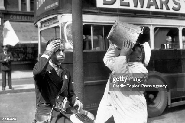 Bus driver and conductor stop for a water break during a heatwave in London.