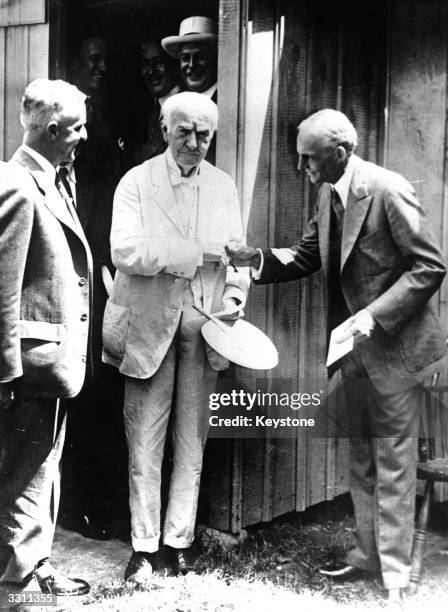 Henry Ford greets inventor Thomas Edison .
