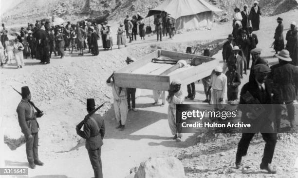 Soldiers watching treasures being removed from Tutankhamun's tomb.