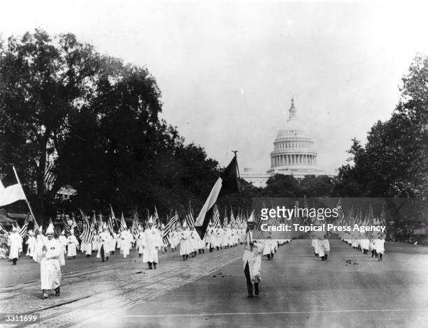 Members of the American white supremacist organisation, the Ku Klux Klan, parade down Pennsylvania Avenue from the capitol to the treasury,...