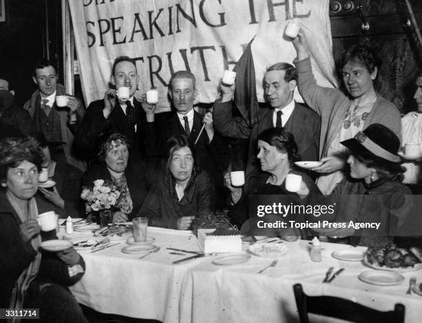 Recently released from prison, militant suffragette leader Sylvia Pankhurst is toasted at a celebration breakfast in East London.