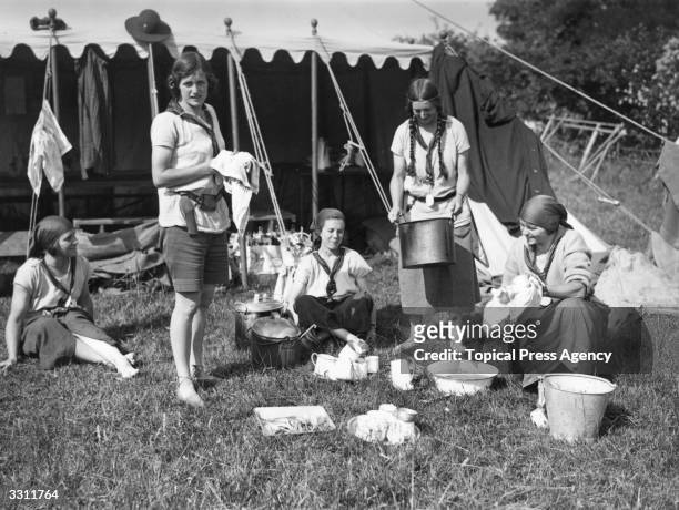 Swiss girl guides at work in their camp kitchen at an International Girl Guide Rally in Hampshire.