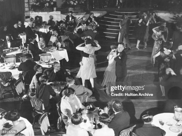 People dancing and dining at London's Palm Beach Cafe, on the bank of the River Thames.