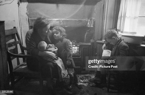 Family at home in the Gorbals area of Glasgow. The Gorbals tenements were built quickly and cheaply in the 1840s, providing housing for Glasgow's...