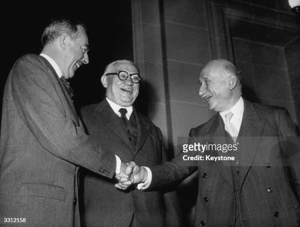 The French prime minister Robert Schuman, the British secretary of state for foreign affairs Ernest Bevin, and American statesman Dean Acheson meet...