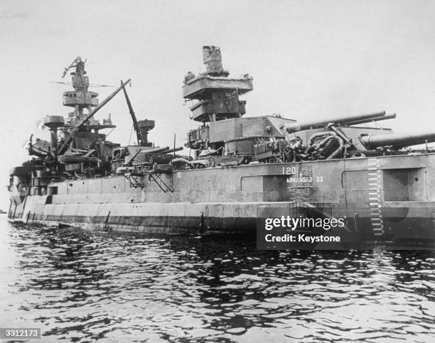 One of the ships which survived the atomic bomb explosion at Bikini Atoll - the battleship USS Arkansas. The bomb was dropped from 'Dave's Dream', on...