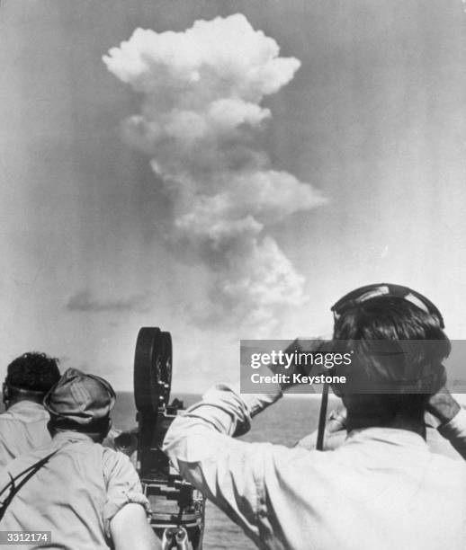The huge swirling mushroom cloud that billowed up from Bikini lagoon seconds after the detonation of the Atomic Bomb, and observers and photographers...