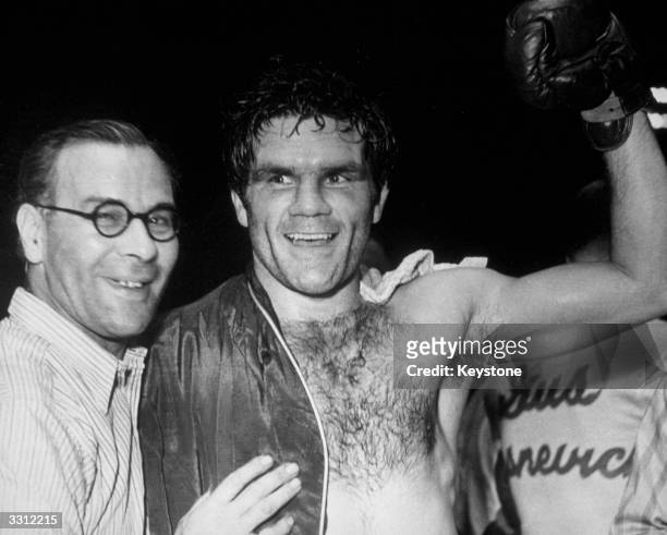 British boxer Freddie Mills celebrates after his world light-heavyweight title victory over US boxer Gus Lesnevich, 1st July 1948.