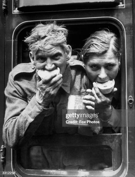 Two soldiers tuck in to the food and refreshment they received after their arrival in Britain, after evacuation from Dunkirk.