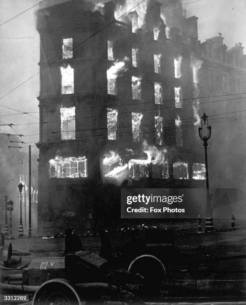 Flames shoot out from all floors of the Negretti and Zambra building in Holborn Circus, following a German air raid on London.