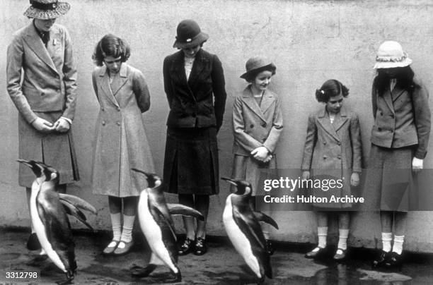Princesses Elizabeth and Margaret , photographed with the penguins at London Zoo.