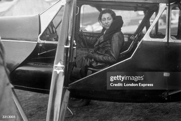 Pilot Amy Johnson, seen in the cockpit of her 'Puss Moth' aeroplane, just before taking off on a flight to South Africa.