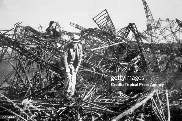 Officials investigating the wreckage of Britain's airship, the R101, which crashed in flames in a forest in Beauvais, near Paris, killing 50 people.