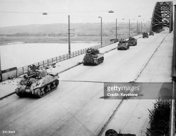 Allied Sherman tanks crossing the newly-captured bridge at Nijmegen in Holland during their advance as part of 'Operation Market Garden'.