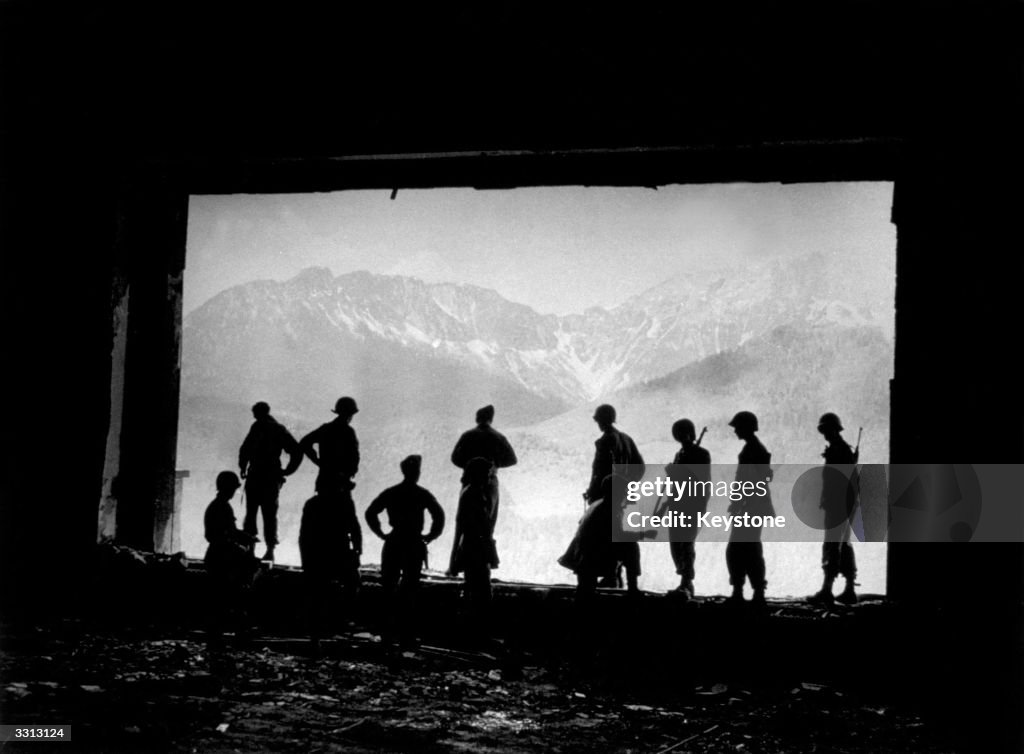 GIs stand at the ruins of the great living room window of Hitler's ...